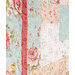 An angled super close up on the patchwork of the quilt, demonstrating fabric colors and print details as well as top stitching effects.