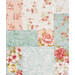 A head-on super close up on the patchwork of the quilt, demonstrating fabric colors and floral print details as well as top stitching effects.