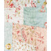 Asuper close up on the patchwork of the quilt, demonstrating fabric colors and floral print details as well as top stitching effects.