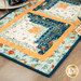 A super close up on one of the log cabin blocks, demonstrating fabric colors and print details as well as top quilting effects.