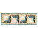 The completed Log Cabin Table Runner colored in autumn-themed fabrics from the I Love Fall Most Of All collection by Moda Fabrics, isolated on a white background.