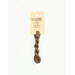 A skein of light chocolate embroidery floss, twisted and bundled, with a cream and black label featuring the brand name and color information.