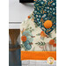 A super close up on the top of the towel, showing color and print details on the cream and blue fabrics.