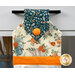 A head on shot of the top of the towel, demonstrating colors and print details of the fall-themed prints.