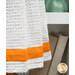 A super close up on the orange fabric stripe running across the bottom of the towel.