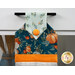 A head on shot of the top of the towel, demonstrating colors and print details of the fall-themed prints.