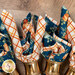 A super close up on the cloth napkins in golden rings, demonstrating fabric color and print details.