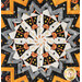 A top-down shot of the kaleidoscope centerpiece of the topper, showcasing an orange cat in wizard robes.