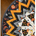 A close up on the outer folded points of the table topper, demonstrating fabric colors and details.
