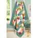 The completed Jelly Sticks Quilt colored in cheery teal, red, gold, pink, and red calico prints from the Gentler Times collection, draped over a white ladder for the effect of movement.