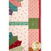 A shot of the side of the wall hanging, showcasing the patchwork details on the border and binding.