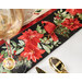 A super close up on one part of the runner, showing details on the floral-themed fabric used as the border print, featuring birds and poinsettias.