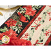 A super close up on one part of the runner, showing details on the floral-themed fabric used as the border print, featuring birds and poinsettias.