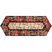 The completed Easy Striped Table Runner colored in floral red, cream, and black fabrics from the Cardinal Celebration collection by Timeless Treasures Fabrics, isolated on a white background.