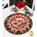 The completed Point of View Folded Star Table Topper colored in black, red, and green fabrics from the Joyful collection. The topper is staged on a white table with coordinating rose decor and tableware.