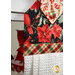 A super close up on the top of the towel, showing color and print details on the black, red, and cream fabrics.
