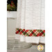 A super close up on the plaid fabric stripe running across the bottom of the towel.