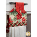 A super close up on the top of the towel, showing color and print details on the red, cream, and green fabrics.