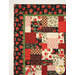 A shot of the top left edge of the quilt, showcasing fabric, border, and binding details.