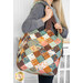 A model holds the Mondo bag over their shoulder, demonstrating size and scale of the bag.