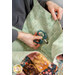 A model inserts a bedazzled pair of scissors into the dimensional pocket of the Mondo Bag.