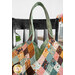 A shot of the Mondo bag on a black chair; a coordinating jar of flowers peeks into frame from the right side.