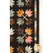 A closer look at the patchwork leaves and inner border of the quilt, showing fabric color and print details.
