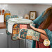 A model demonstrates use of the hot pads, holding a casserole in a kitchen scene.