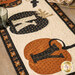  A close up on the appliqué pumpkins and letters of the runner, showing fabric color and print details as well as topstitching effects.