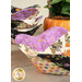 A close up photo of a bowl cozy, while a blurred stack of other coordinating cozies and decor sit in the background.