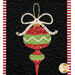A close up on one of the window blocks, showcasing a Christmas ornament with a bow.
