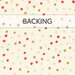 A swatch of cream fabric with red, gold, pink, blue, and green scattered polka dots. A banner at the top reads 