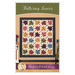 Front cover of the pattern featuring the completed quilt in calming earth tone colors, staged on a warm tan wall with coordinating decor.