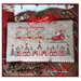 The completed project, santa flying over a christmas village, staged with coordinating holiday decor.