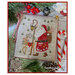 The completed project, santa claus with a reindeer hiking through the woods, staged with coordinating holiday decor.