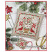 The completed project, a christmas floral design with a small scissor fob, staged with coordinating holiday decor.