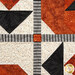 A super close up on the center of the project, showing details on the black and white striped sashing of the quilt. 