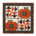 The completed Pieceful Patchwork - October wall hanging, a combination of patchwork pumpkin and flying geese blocks colored in cream, orange, and black Halloween fabrics, isolated on a white background.