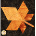 A super close up on a golden yellow and orange pieced leaf set against a contrasting black-brown background, demonstrating fabric color and print details.