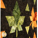 A super close up on a green pieced leaf set against a contrasting black-brown background, demonstrating fabric color and print details.