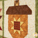A close up on one of the patchwork acorns, showing details on the fabric colors and prints as well as top quilting effects.