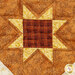 A super close up on one of the sawtooth stars on the acorn, showing patchwork and fabric details as well as top quilting effects.