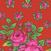 Tomato red fabric with bright pink roses with small rosebuds in the background.