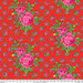 Tomato red fabric with bright pink roses with small rosebuds in the background.