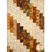 A head-on close up on the patchwork of the quilt, showing fabric details on the falling strip pieces of the quilt.