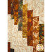 An angled super close up on the patchwork of the quilt, showing fabric details on the falling strip pieces of the quilt.