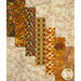 A super close up on the patchwork of the quilt, showing fabric print details on the strip pieces of the quilt.
