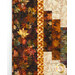 A super close up on one section of the quilt, showing fabric print details on the strip pieces as well as the inner and outer borders.