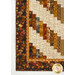 A close up on the lower left corner of the quilt, demonstrating details on the inner and outer border fabrics.