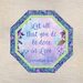 Mockup of a completed panel table topper in blue, purple, and green butterfly themed fabrics with the words "Let all that you do be done in Love - 1 Corinthians 16:14" centered.